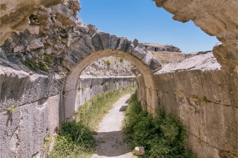 Ancient Roman Theater Archway Creating Passage Along Path With Stone Walls Historical Architecture Sunlight